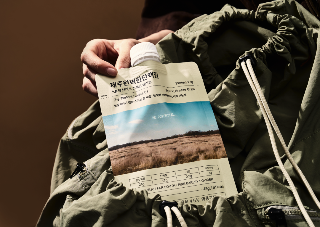제주 보리 단백질 쉐이크 제품을 들고 있는 손 : 제주완벽한단백질 Spring Breeze Grain BE POTENTIAL